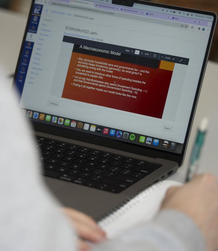 laptop open to an Economic slide