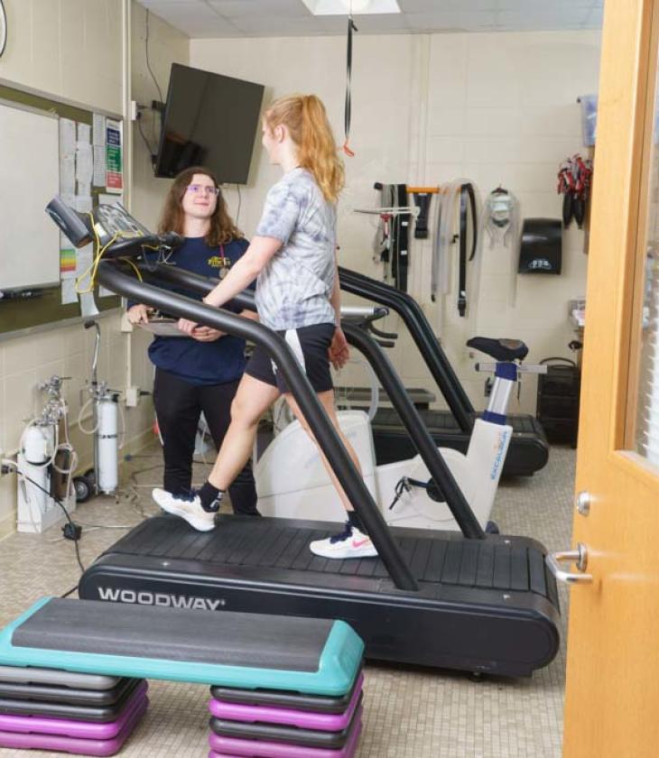 Exercise science lab, girl on treadmill with observer