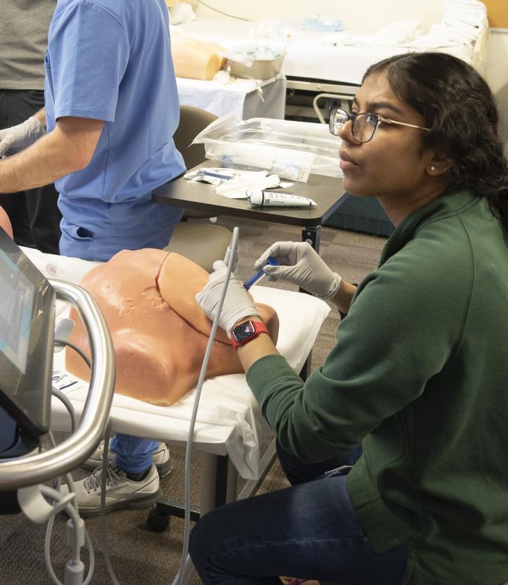 Student in procedural skills lab learning ultrasound technology.