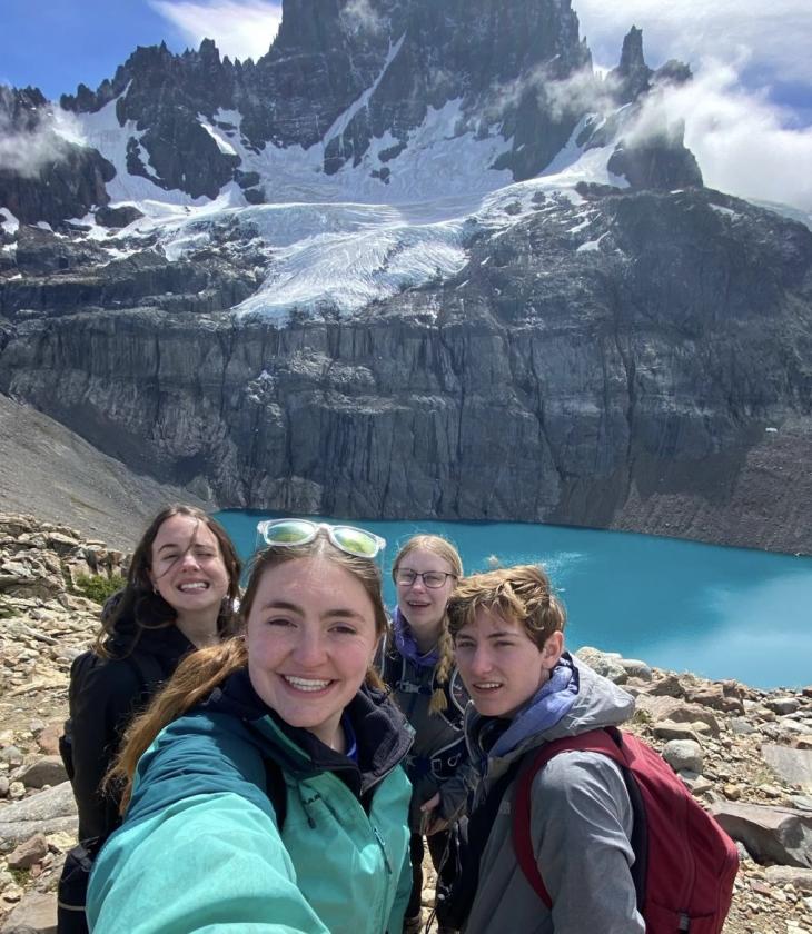 four students in front of a glacial lake in Chile