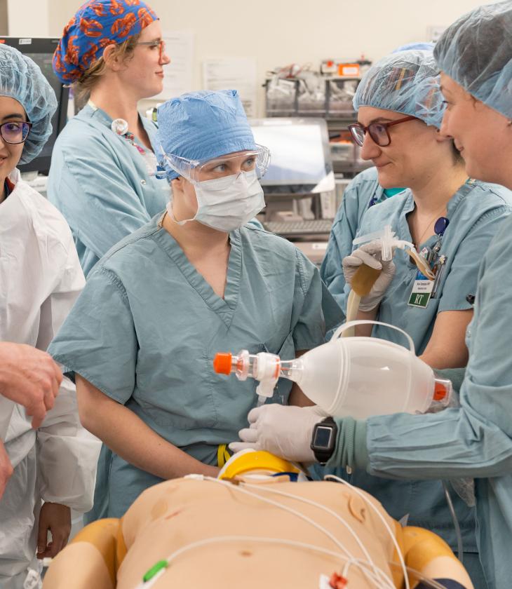 A student works among Mayo doctors during a simulation drill.
