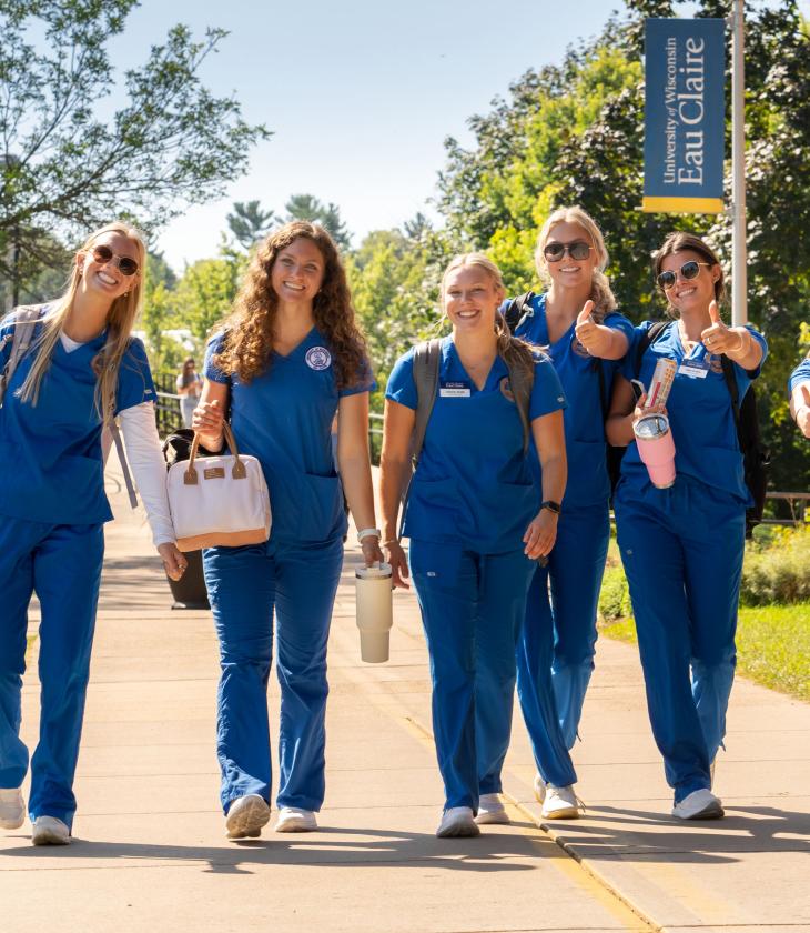 nursing students outside walking in scrubs