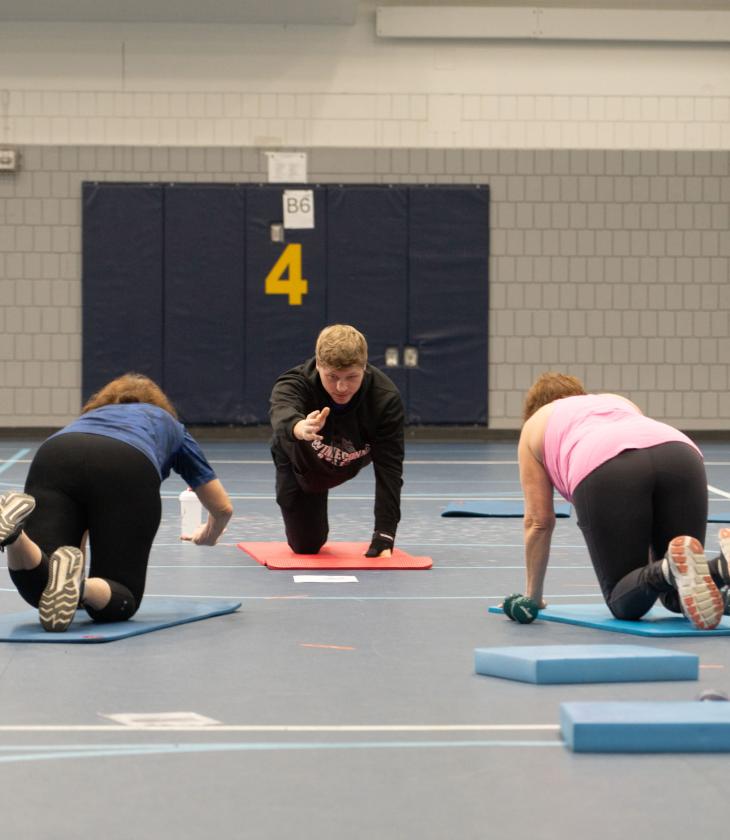 group class in community fitness with KINS teaching assistant