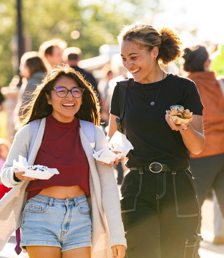 Students laugh and enjoy food at the annual UWEC Meets EC event.