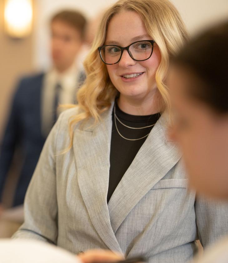 Closeup of a student listening to another student talk.