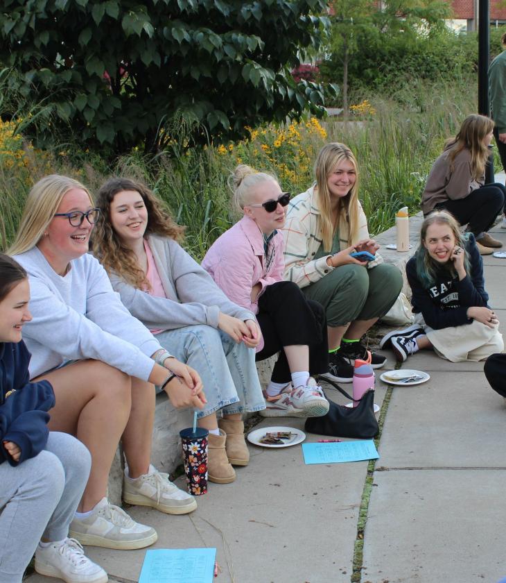 Honors LLC students sit in a circle and laugh during Catalyst, the honors early move-in program