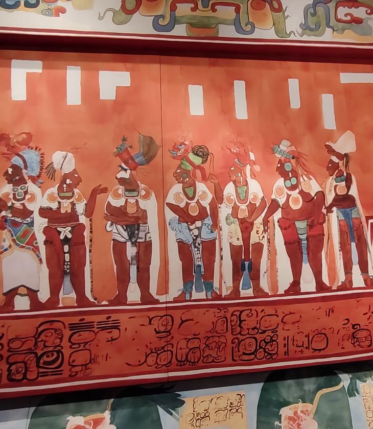 A colorful mural portraying a group of people from Latin America.