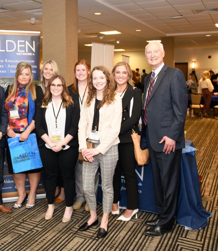A group of people gather for a photo at the 2022 CHAASE Health Care Administration Annual Banquet