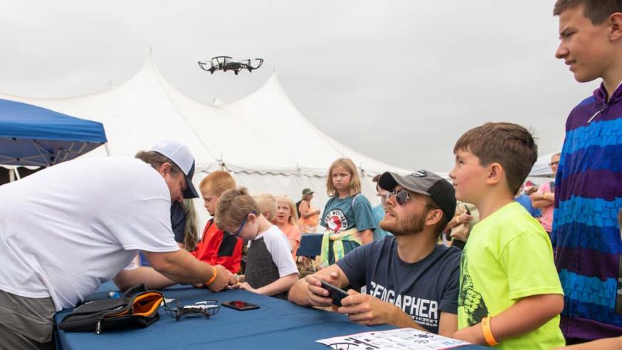 Geography student and youth with drone