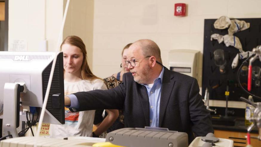 Jim Phillips and students in chem lab