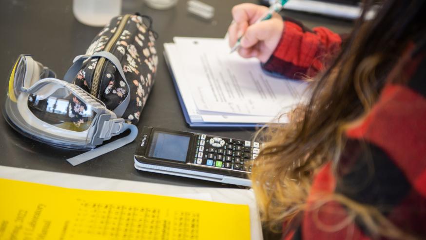 books and supplies on a chemcistry lab table 