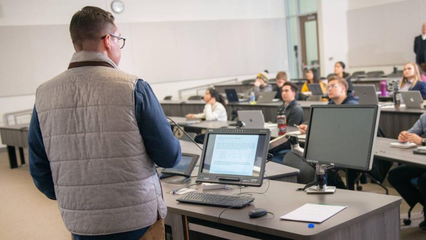 students in a classroom in a business course, stadium seating rows 