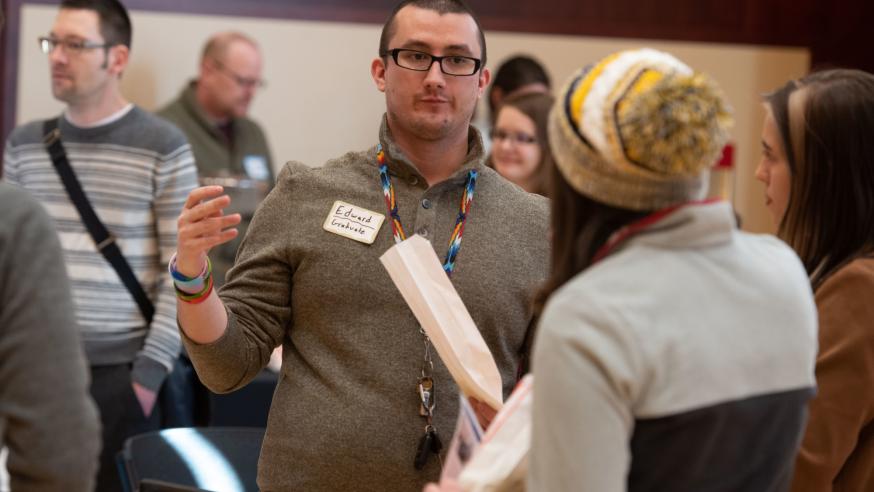 Student and alumnus at psych open house