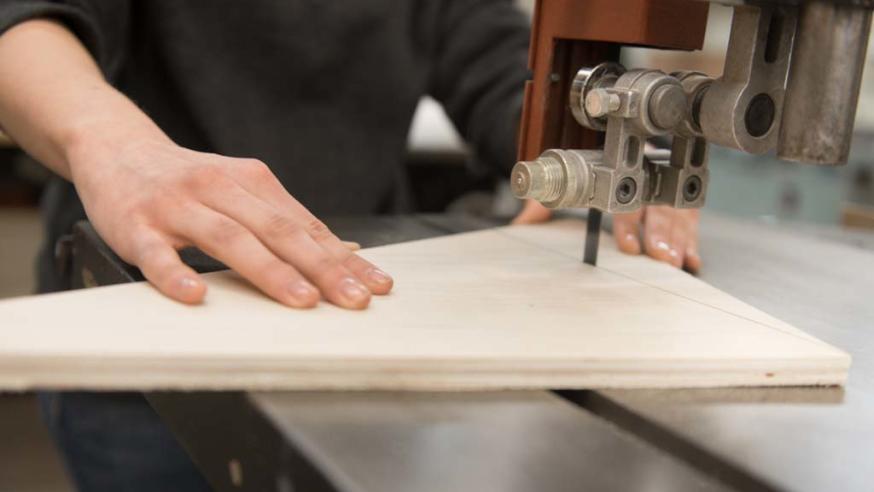 student using table saw in art class