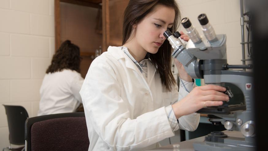 student at microscope