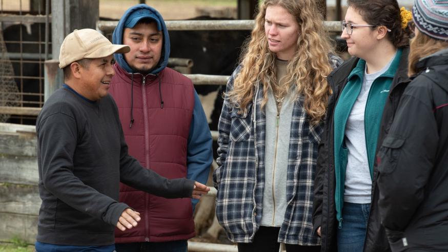student at regional farm speaking Spanish with farm staff