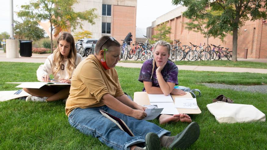 drawing student and Cedar Marie outside for class