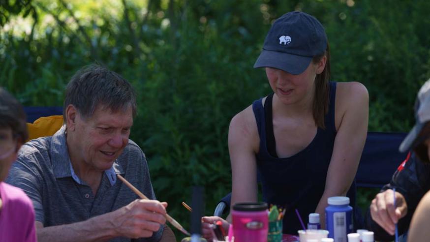 student working with aphasia patient at CSD garden