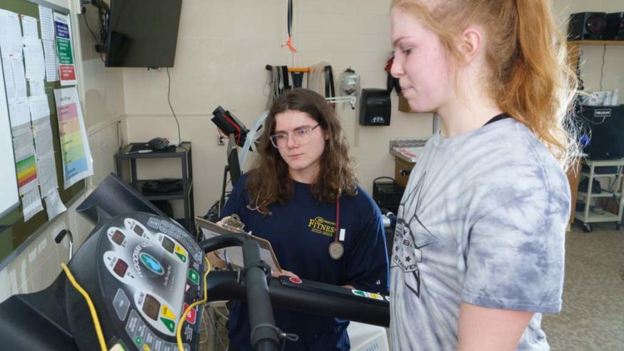 KINS student working on evaluation of student on treadmill 