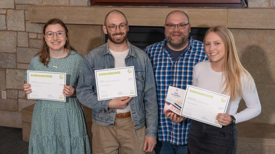 Josh Brown with three students at languages awards night 