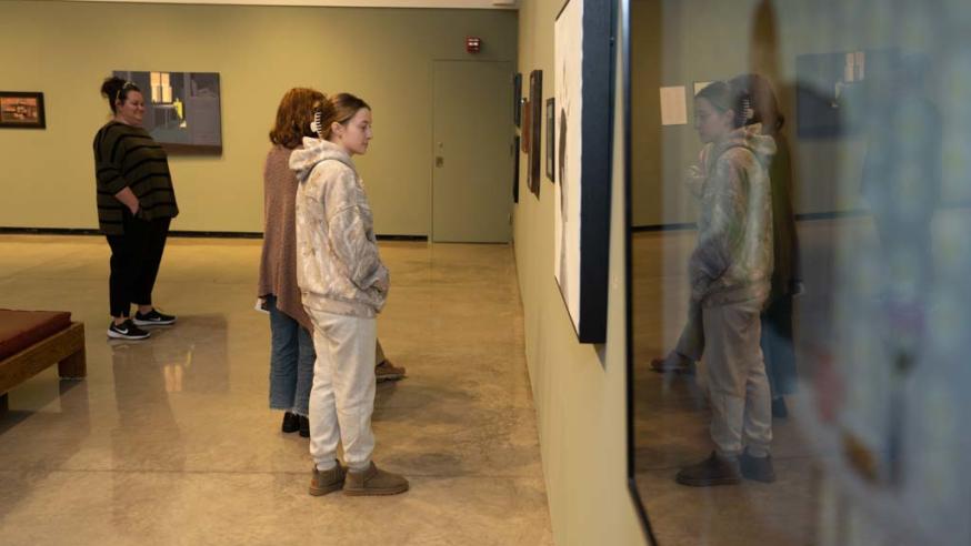 students in art gallery looking at wall art