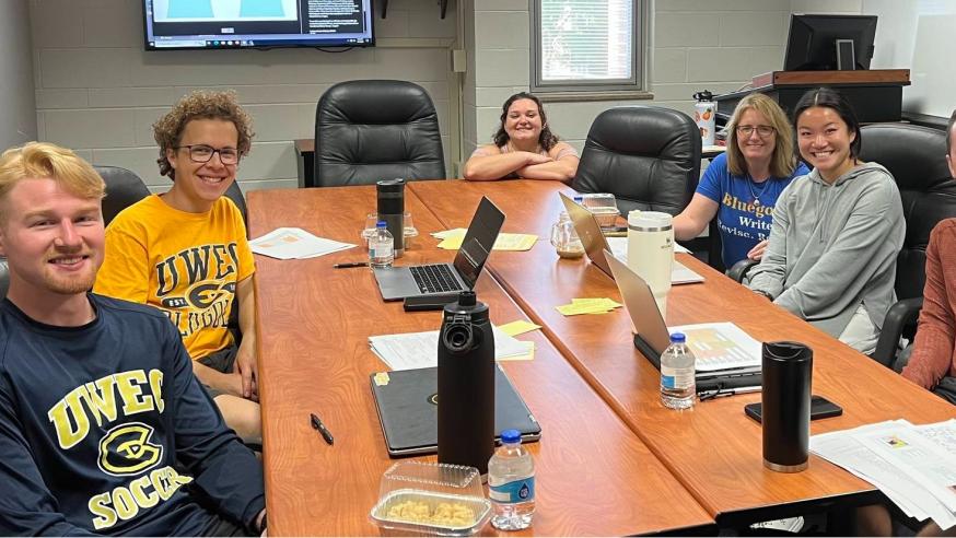 students in business writing class at a table 