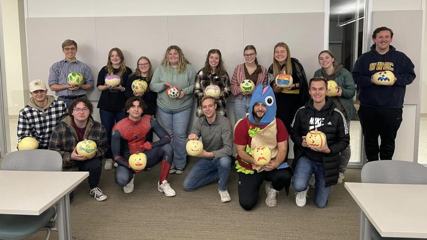 DECA student painting pumpkins