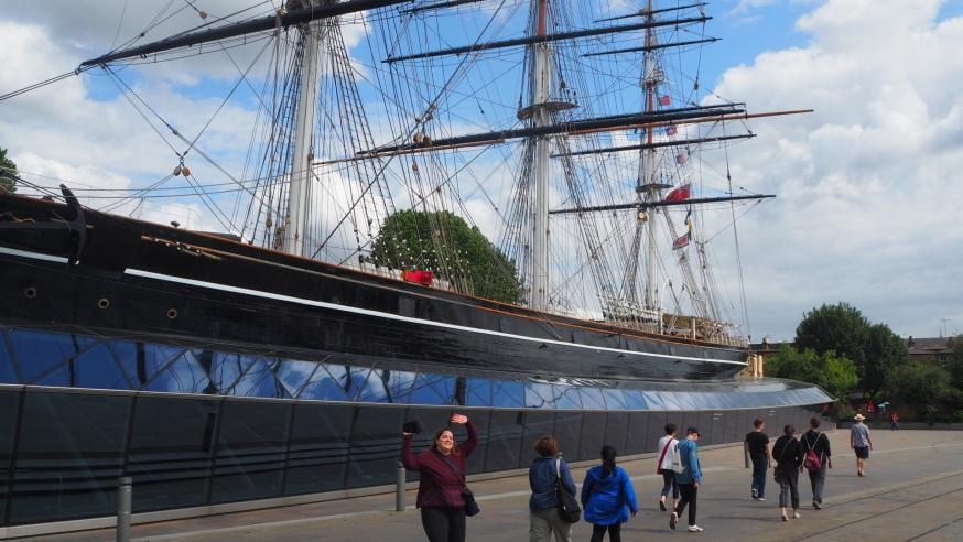 Students seeing old ship on London port 