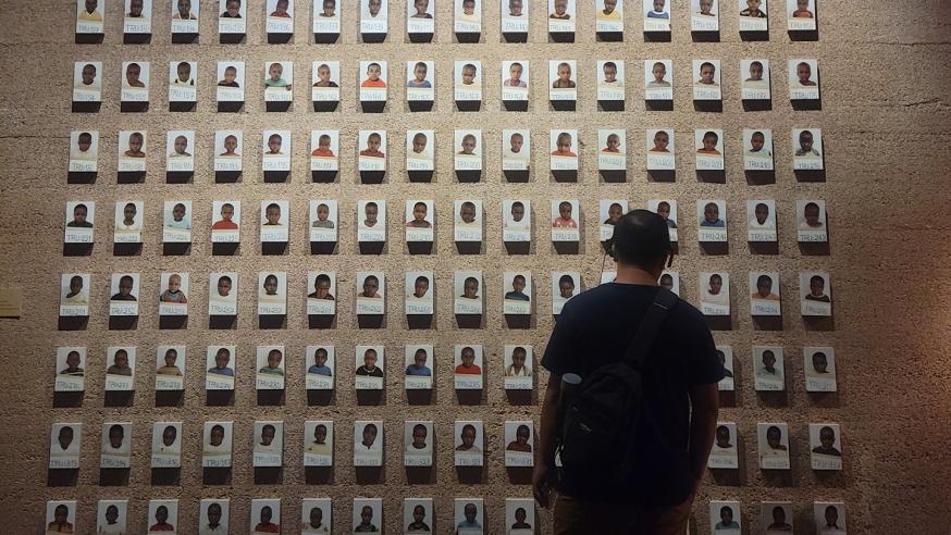 student in front of a large memorial wall