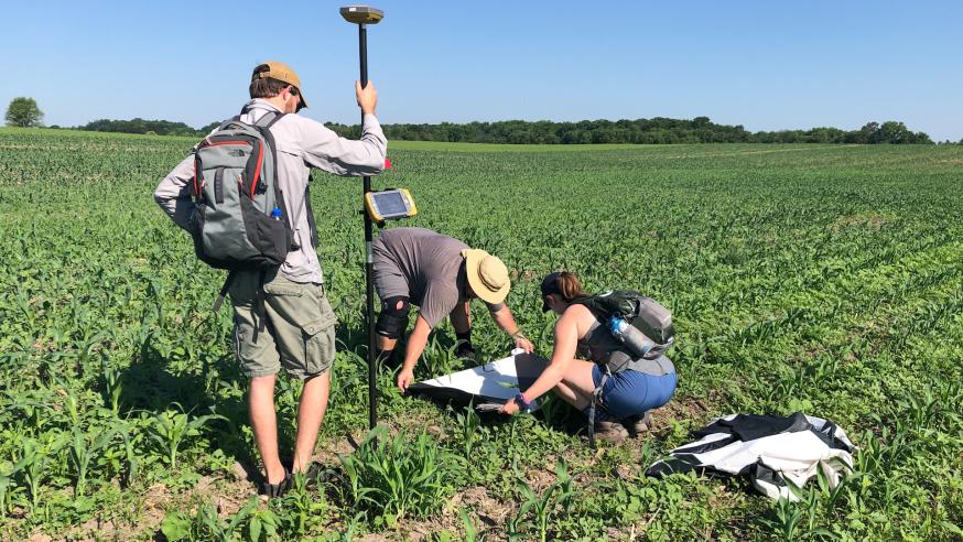students and faculty using geospatial tech in a local farm field
