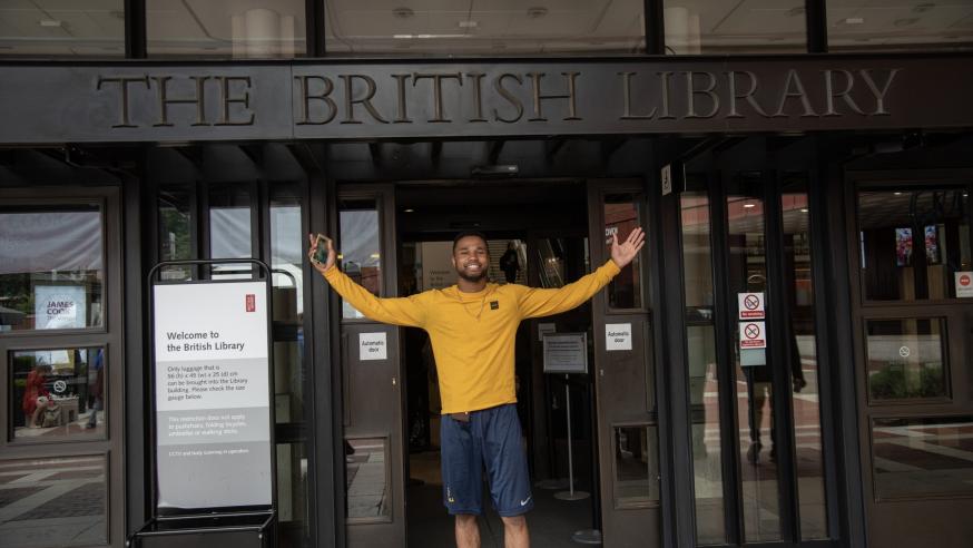 Blugold student in front of British Library sign 