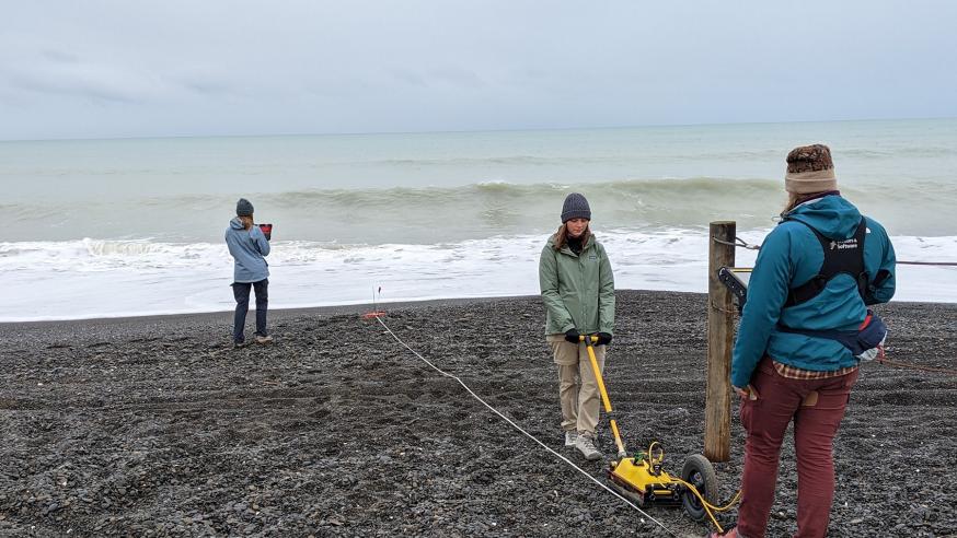 student using ground radar tech near ocean shore