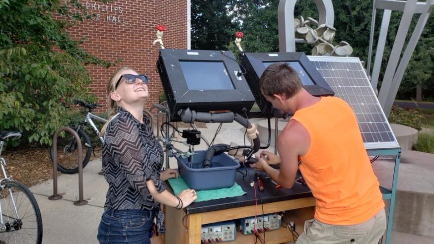 two students working with solar water heater