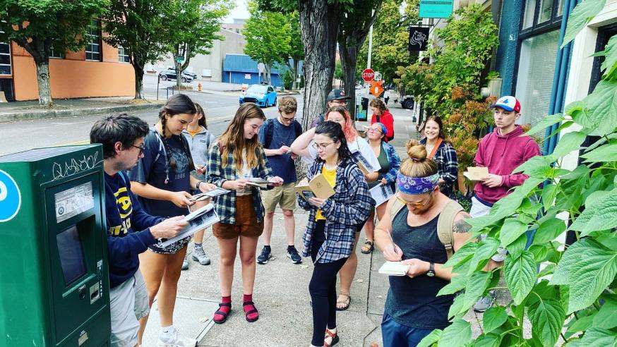 geography students in a city using maps