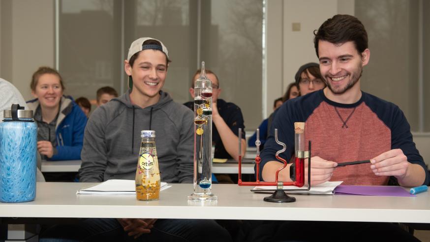 Physics students in class with instruments