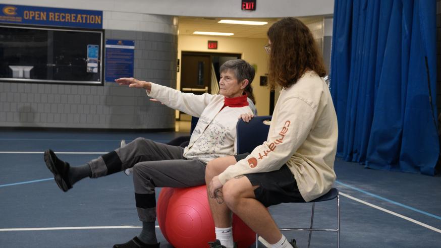 senior rehab client with student