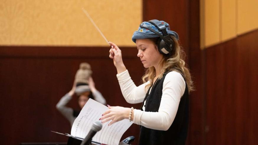 student conducting rehearsal 