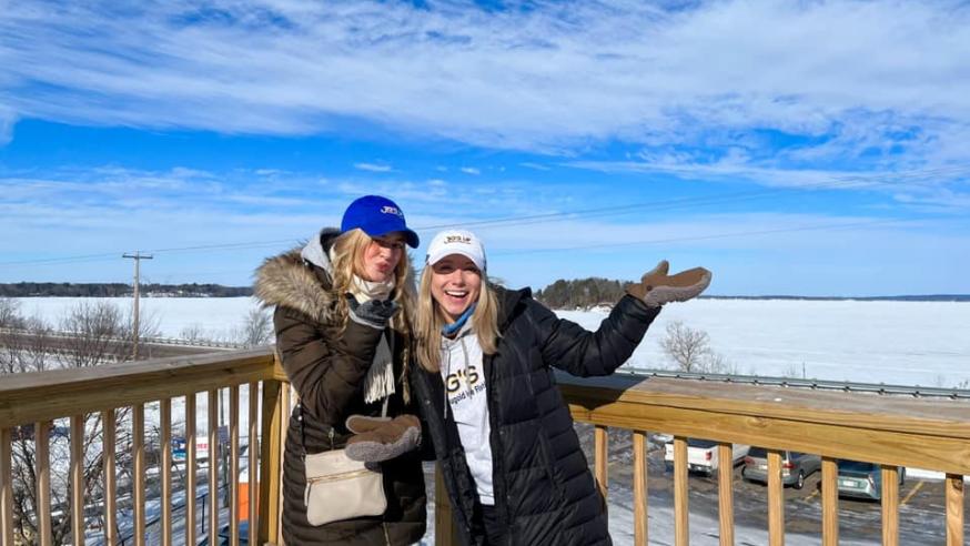 Kjerstin Carlson, right, 3rd year PR intern for the Jig's UP ice fishing