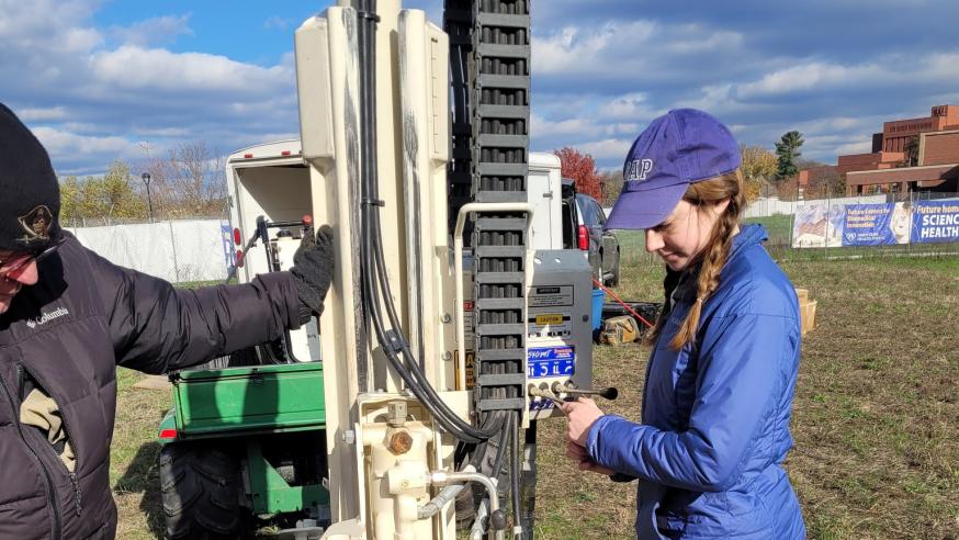 female student using geology core sample machine