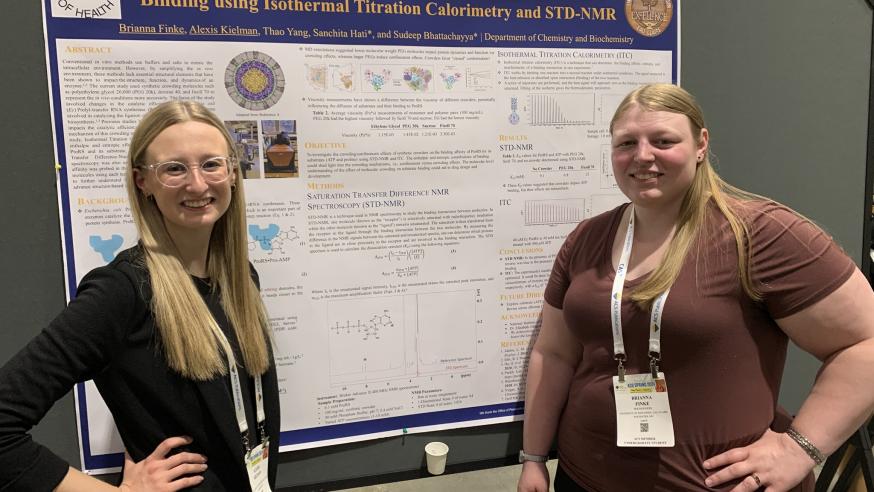 two students presenting chemistry/biochem research 