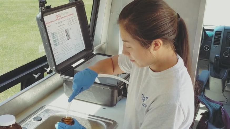 female Geology intern on work site in a vehicle 