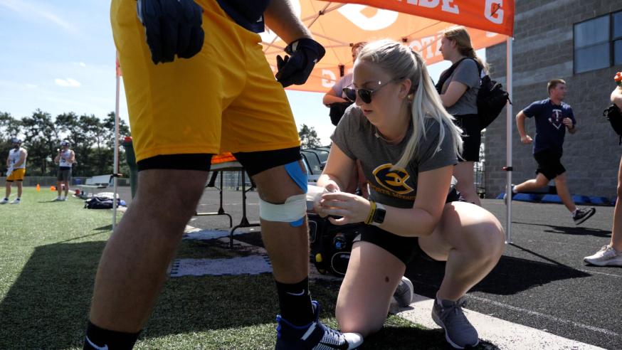 athletic training student working a football game