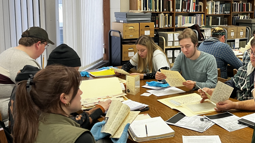 students in group research in library archives