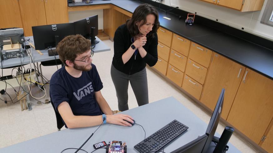 Elizabeth Radue helping physics robotics student 
