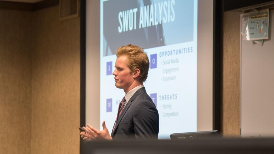 Marketing student presenting a SWOT Analysis and marketing research to Mayo Clinic Health System and faculty for marketing capstone course.