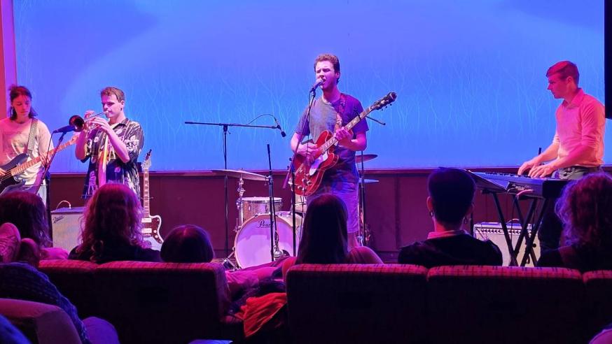 Four band members performing in The Cabin