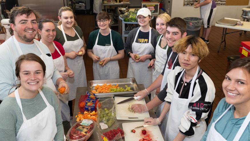 Students preparing a meal at Community Table