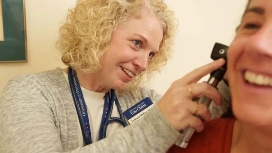 A person gets their ears looked at in student health service.