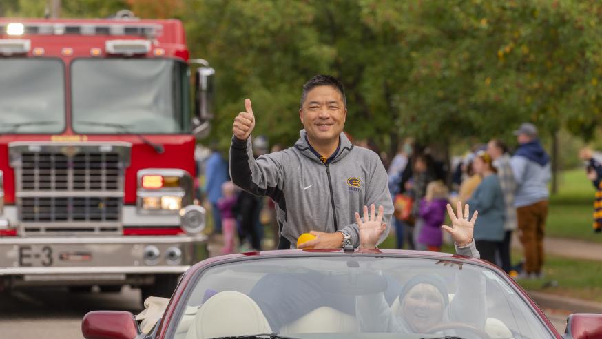 Eric Wan in a red car for 2023 Homecoming Parade 