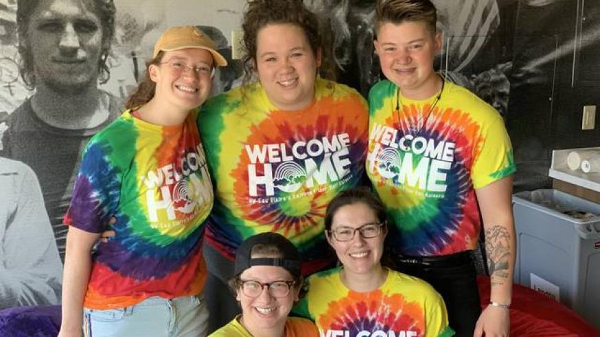 A group of students smiles for the camera.
